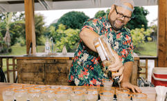 A bartender prepares a round of mai tais for guests taking the Kauai Rum Safari Tour at Kilohana Plantation.