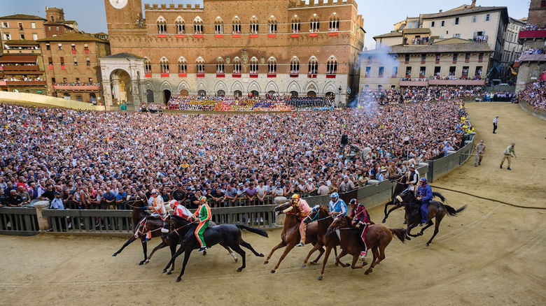 The Palio di Siena horse race on the Main Square in Siena, Italy. Red Savannah packages travel around the event.